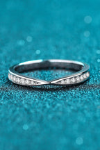 Rhodium-plated moissanite ring with sparkling gemstones, elegant jewelry piece showcasing intricate design and shine.