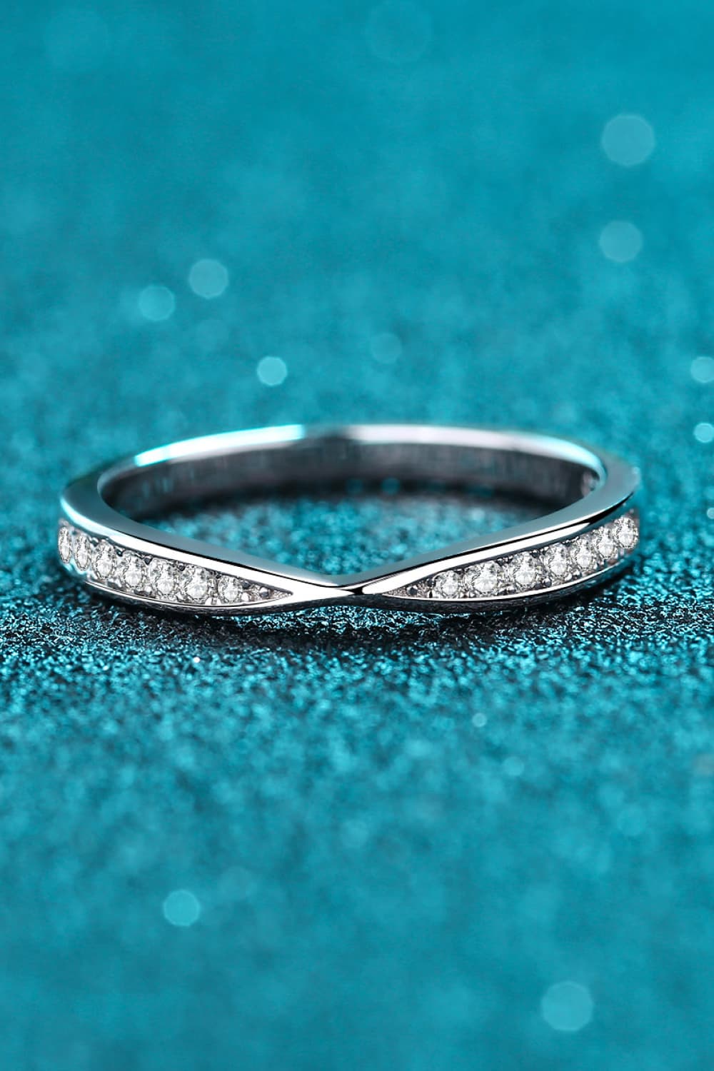 Rhodium-plated moissanite ring with sparkling gemstones, elegant jewelry piece showcasing intricate design and shine.