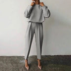 Women’s solid color 2-piece loungewear set by Plush Fashion Hub, long sleeve top and pleated pants for casual wear.