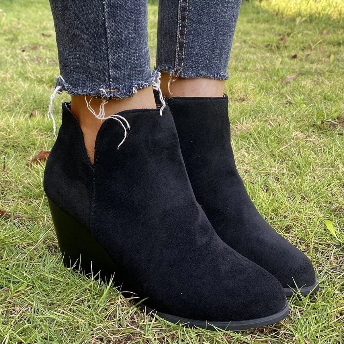 Trendsi round toe wedge ankle boots in black leather featuring a sleek design and ankle-high style.