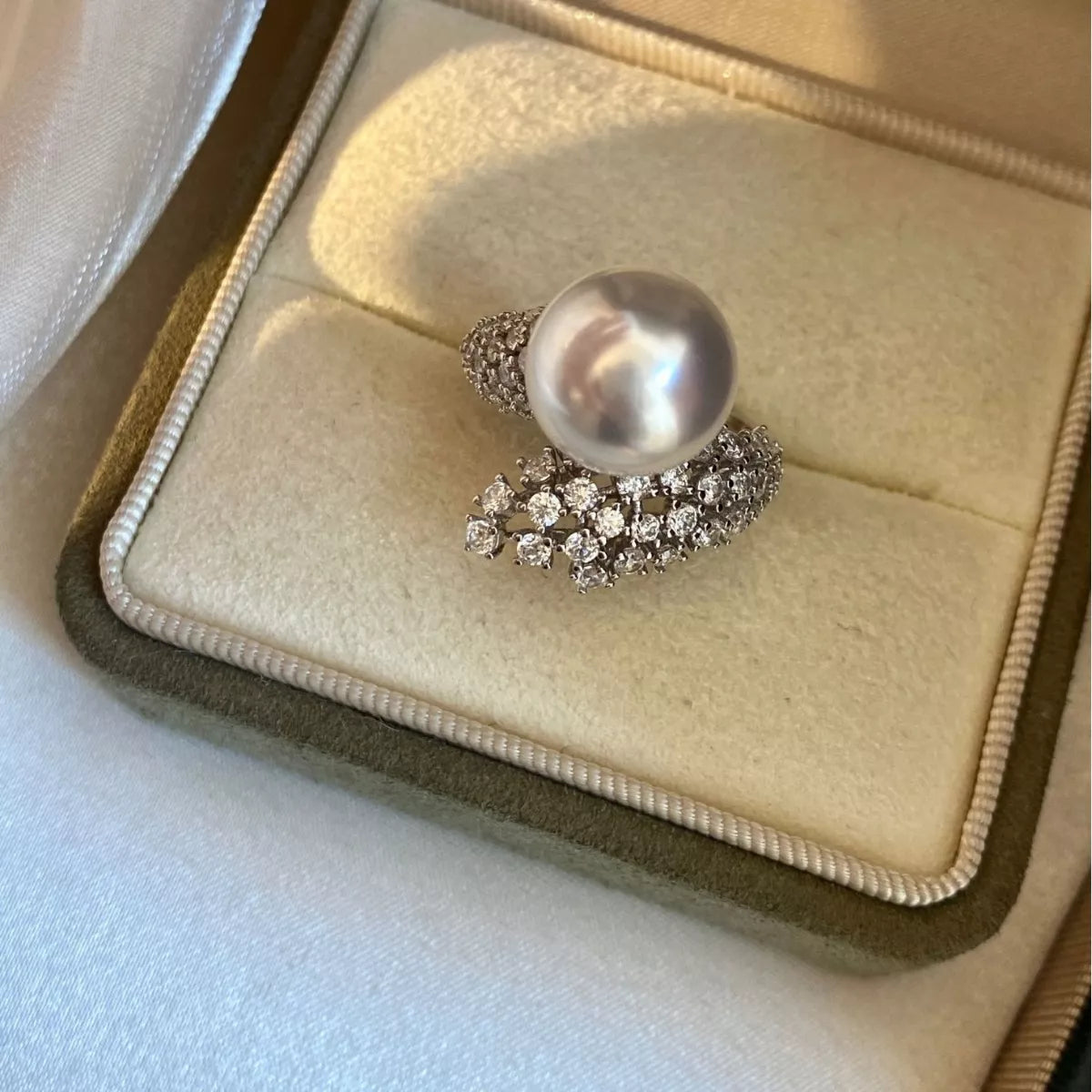 Sterling silver bypass ring with pearl accents, stylish jewelry from Plush Fashion Hub, showcasing the elegant design and craftsmanship.