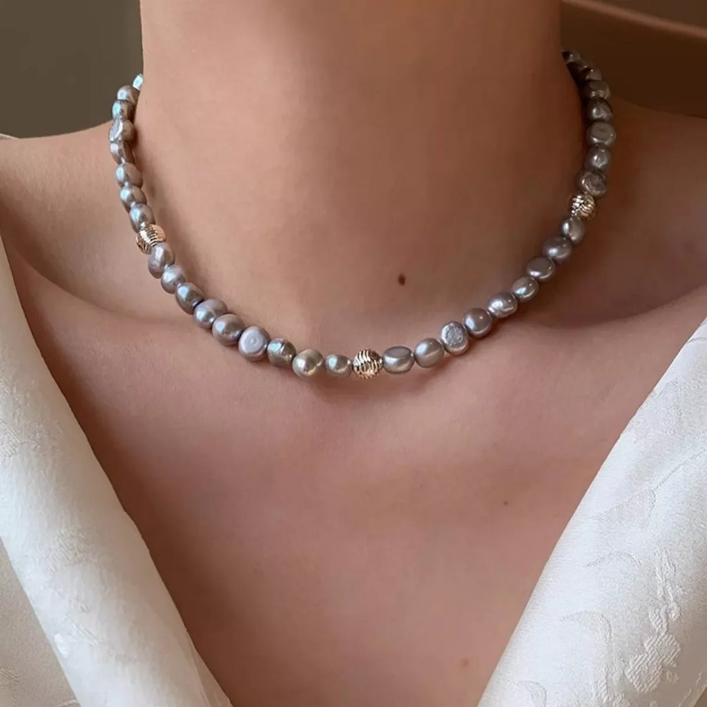 Elegant pearl choker necklace by Shopimist featuring a string of lustrous white pearls on a delicate chain.