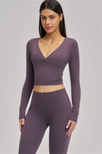 Fitglutes Activewear long sleeve crop top from The Swoon collection, featuring a fitted design and stylish workout apparel.