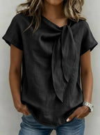 Light beige women's loose-fit short sleeve casual pullover T-shirt by Plush Fashion Hub, shown on a hanger.