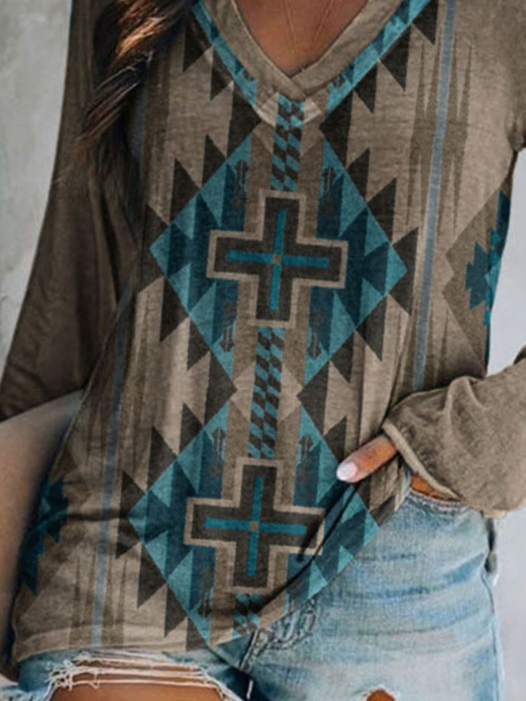 Plus size V-neck T-shirt with geometric print by Trendsi, featuring long sleeves and a comfortable casual fit.