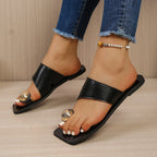 Flat sandals with toe ring design from Shopimist, featuring a minimalist style and neutral-colored straps.