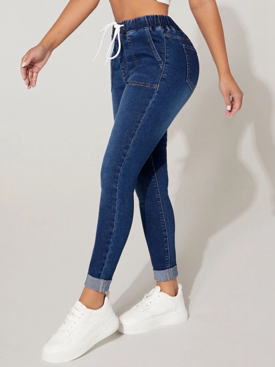 Plush Fashion Hub drawstring cropped denim jeans with relaxed fit, high waist, and distressed details, styled casually.