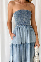 VYSN smocked tube slit tiered denim dress showing a fitted bodice, tiered skirt, and slit detail on a model.
