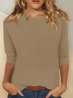 Solid color round neck T-shirt from Trendsi, featuring a classic fit and smooth fabric, displayed on a neutral background.