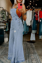 Women’s distressed wide leg denim overalls from Plush Fashion Hub featuring casual relaxed fit bottoms and distressed details.
