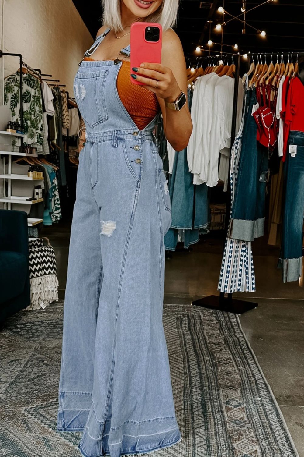 Women’s distressed wide leg denim overalls from Plush Fashion Hub featuring casual relaxed fit bottoms and distressed details.