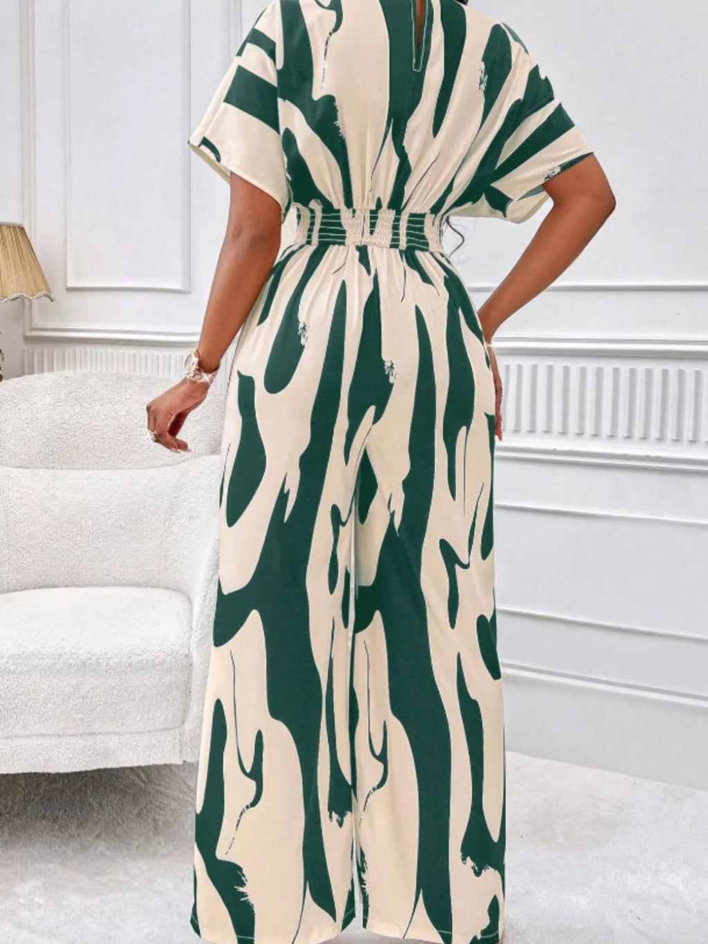 Abstract print wide-leg jumpsuit by Trendsi, featuring a flowing design and stylish pattern perfect for casual or chic occasions.