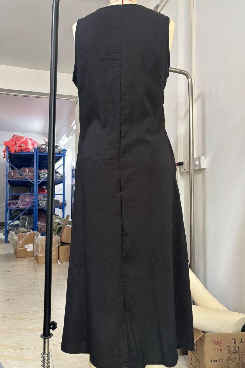 Women's sleeveless button-down midi dress by Trendsi, elegant A-line casual wear with a flattering fit and classic design.