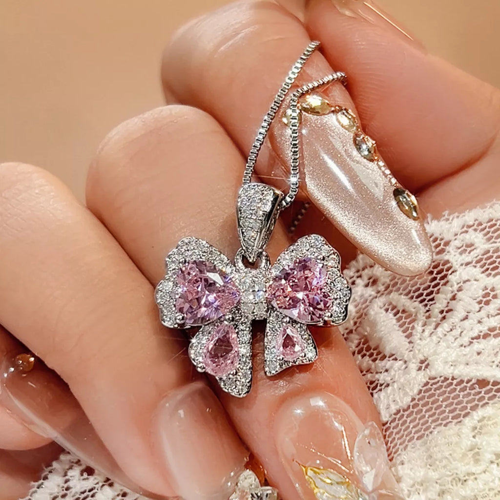 Zircon bow pendant necklace by Shopimist featuring a sparkling zircon stone on a delicate chain, close-up view of the jewelry.