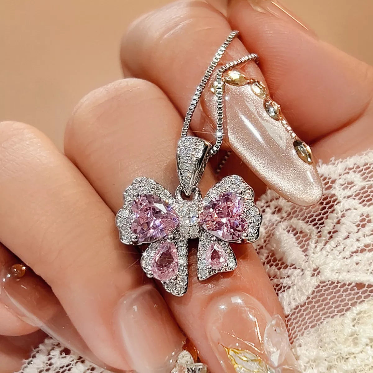 Silver zircon bow pendant necklace featuring a sparkling bow charm on a delicate chain, from Plush Fashion Hub.