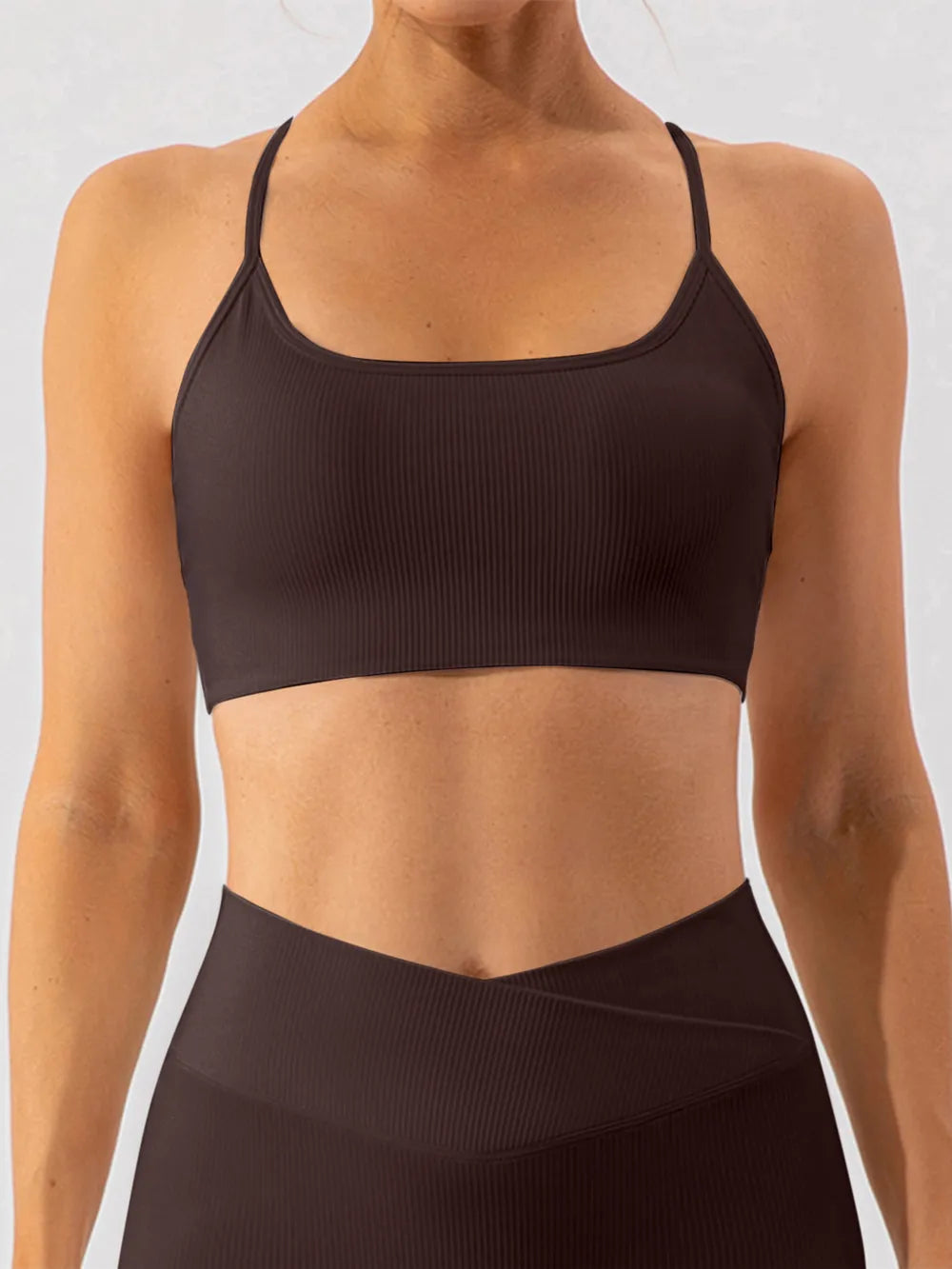 Trendsi spaghetti strap active bra in black, lightweight sportswear with thin straps and supportive design.