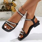 Pearl-embellished open toe low heel sandals for women, stylish and comfortable footwear by Trendsi featuring elegant design details.