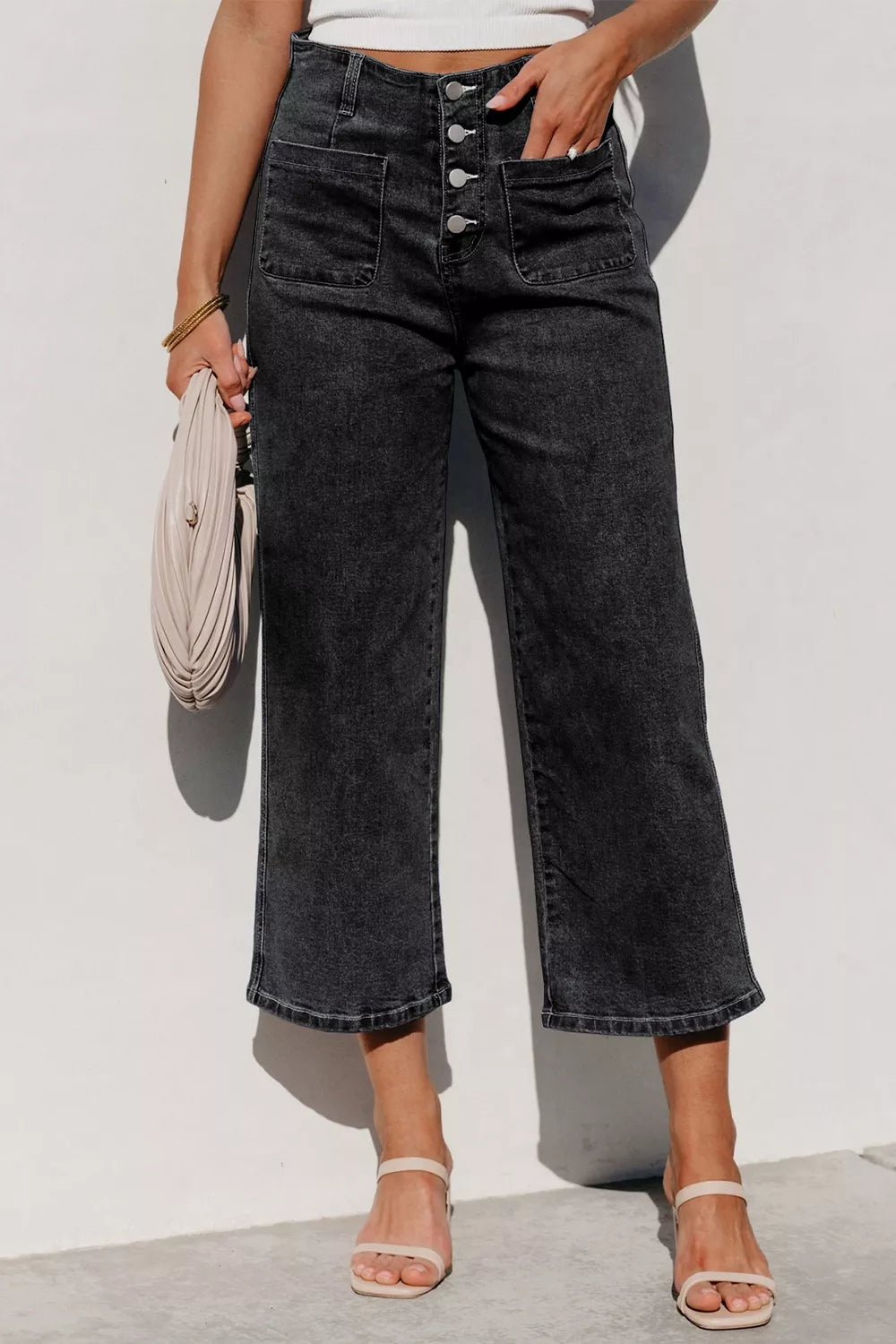 High-waisted button-fly wide-leg jeans by Trendsi displayed on a model, showcasing the relaxed fit and stylish denim.