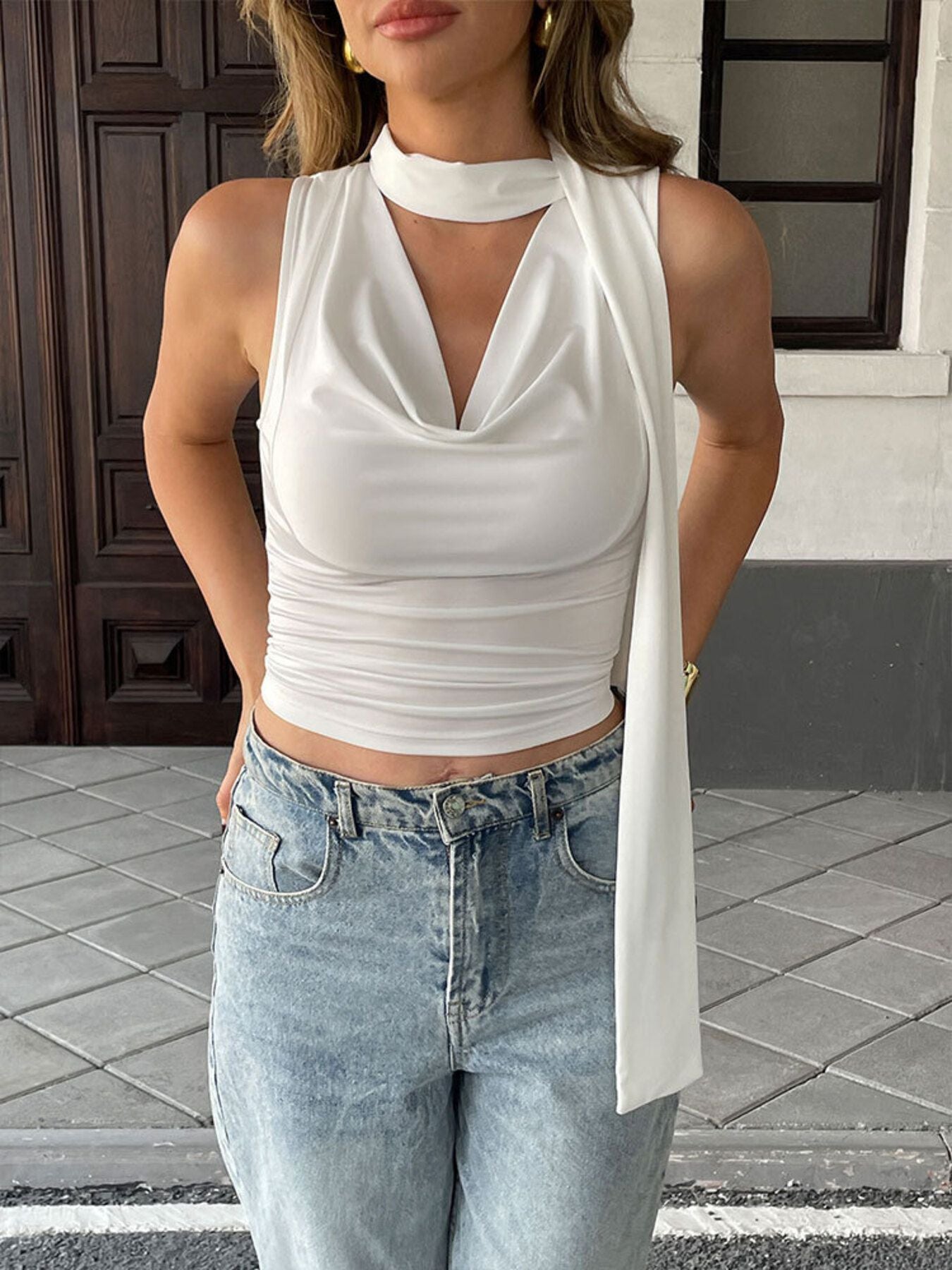 Satin-feel sleeveless cowl neck blouse with ruched details, versatile and stylish, perfect for elegant casual or dressy outfits.