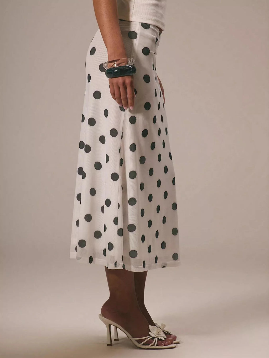 Women's vintage-inspired polka dot midi skirt by Trendsi featuring high-waisted A-line design and classic retro style.