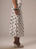 Women's vintage-inspired polka dot midi skirt by Trendsi featuring high-waisted A-line design and classic retro style.