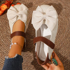 Women's chic bow round toe slip-on flats made of vegan leather by Trendsi, featuring a comfortable design and stylish appearance.