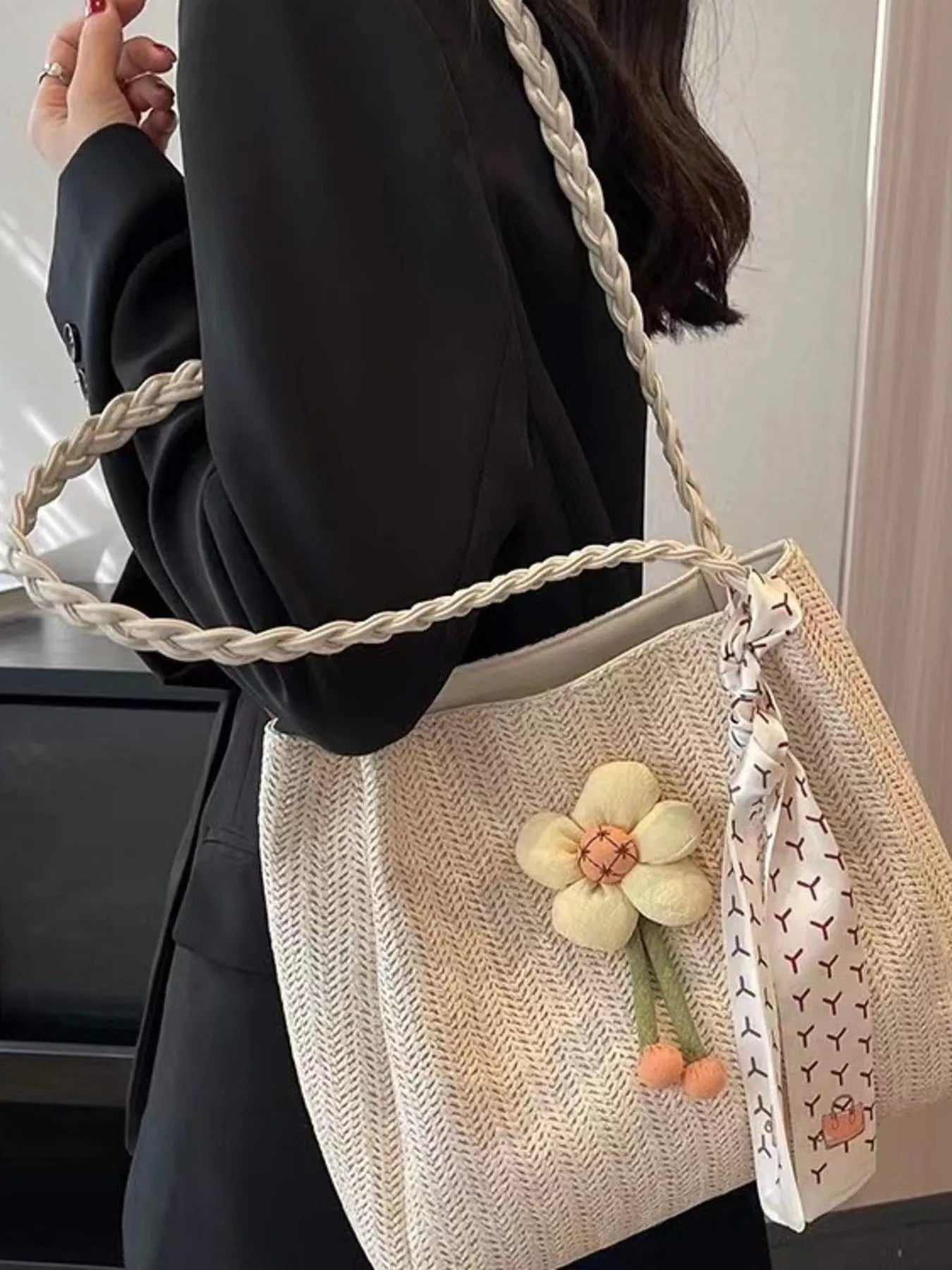 Woven straw tote bag with floral decor, natural color, featuring sturdy handles for casual summer or beach use.