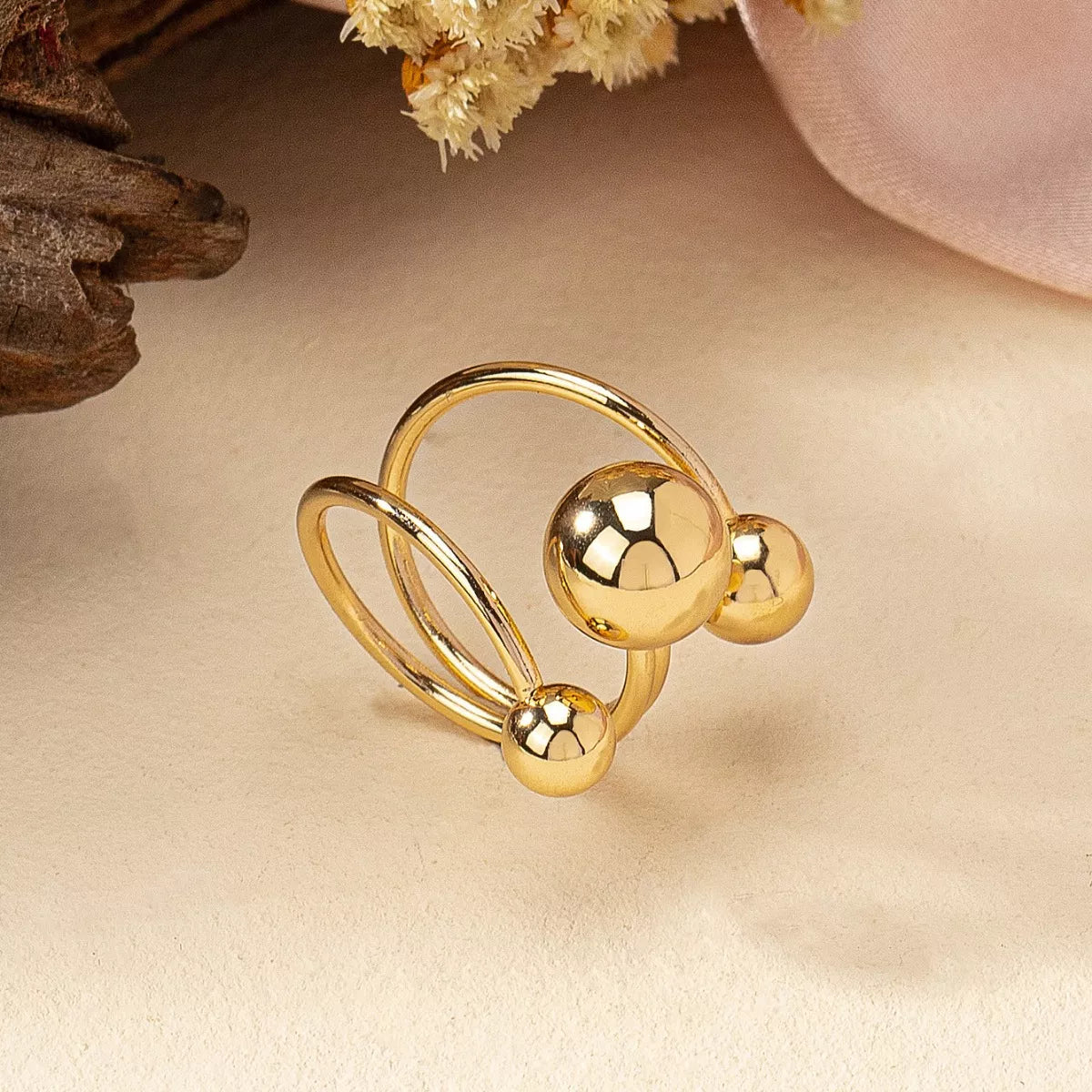 Multi-layered ball ring from Plush Fashion Hub featuring overlapping silver bands and small decorative balls.