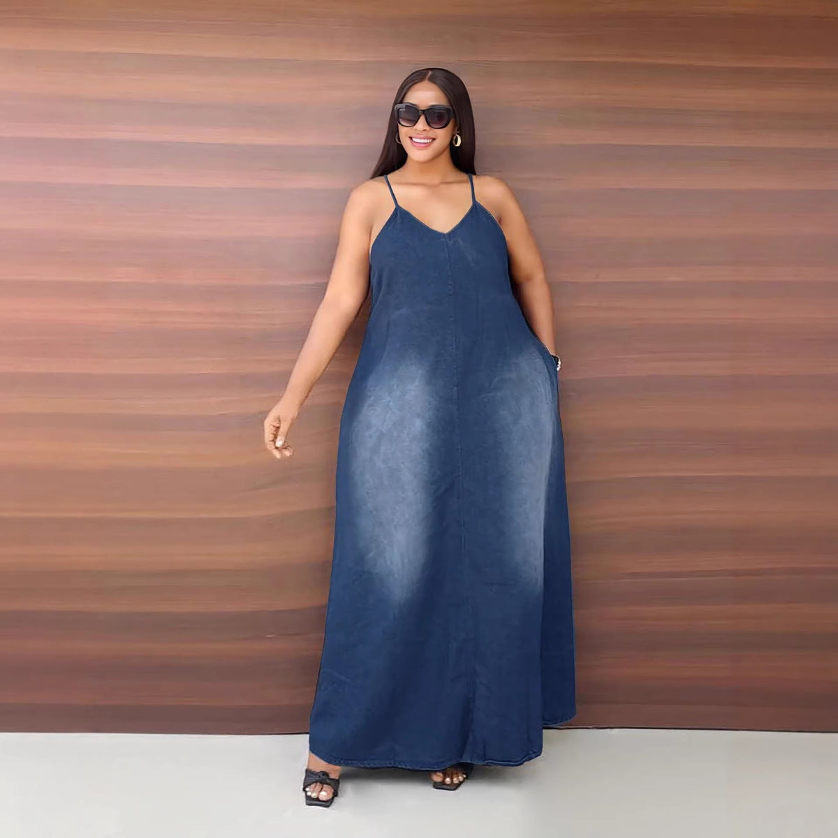 Casual faded denim dress by eprolo with side pockets, loose fit, and strap details, perfect for relaxed everyday wear.