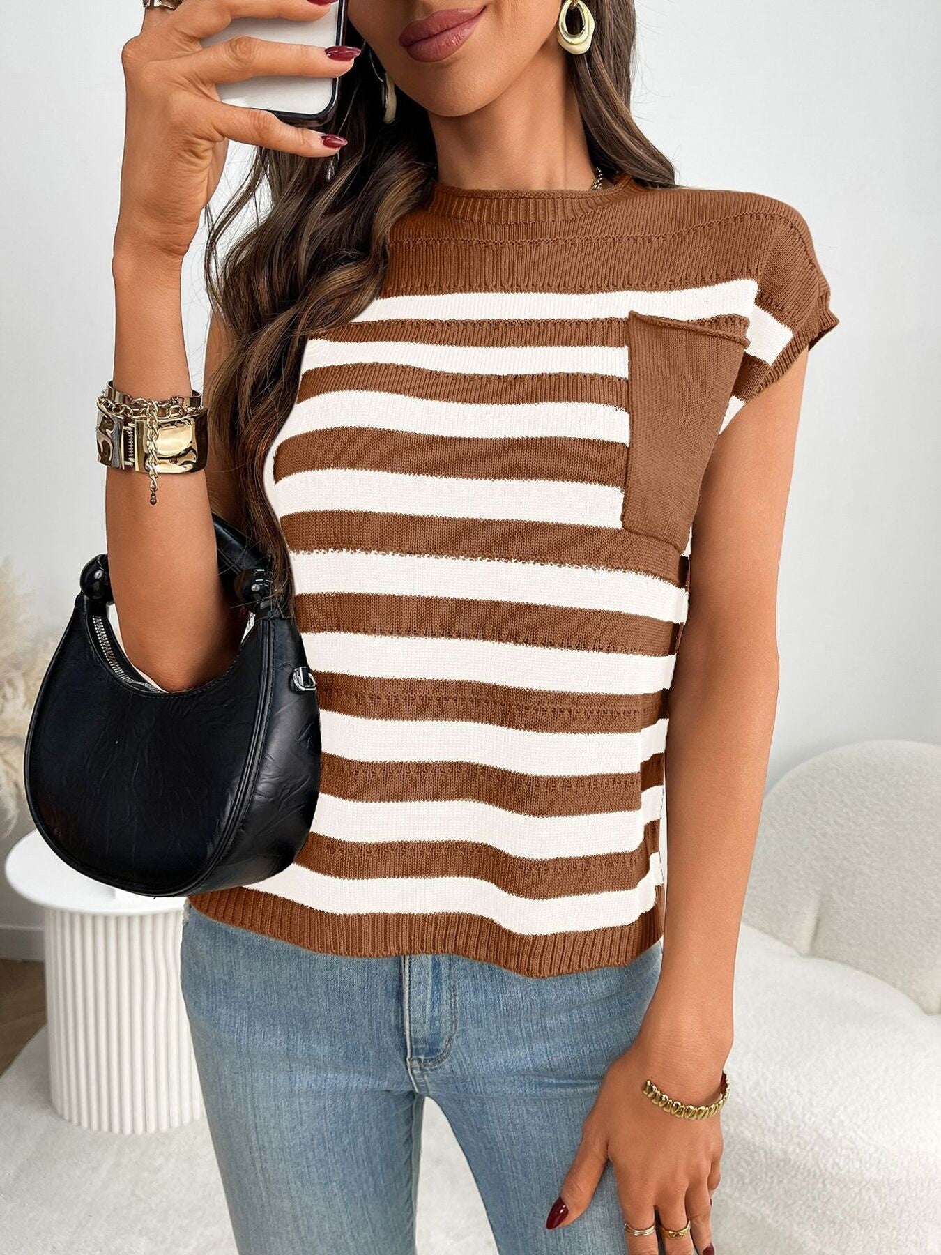 Women's striped knit cap sleeve sweater with pocket detail, stylish outerwear by Trendsi, displayed on a hanger.
