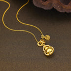 18K gold-plated gourd pendant necklace with intricate design, featuring a delicate chain and shiny finish.