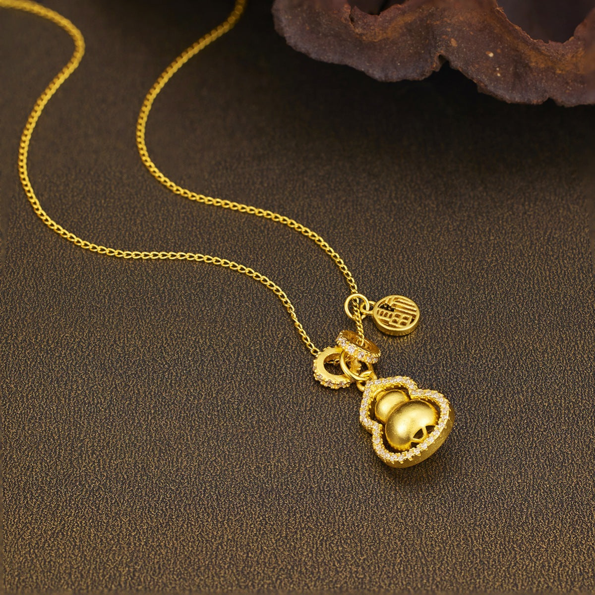 Gold-plated gourd pendant necklace from Plush Fashion Hub featuring a smooth, polished gold-tone design on a delicate chain.