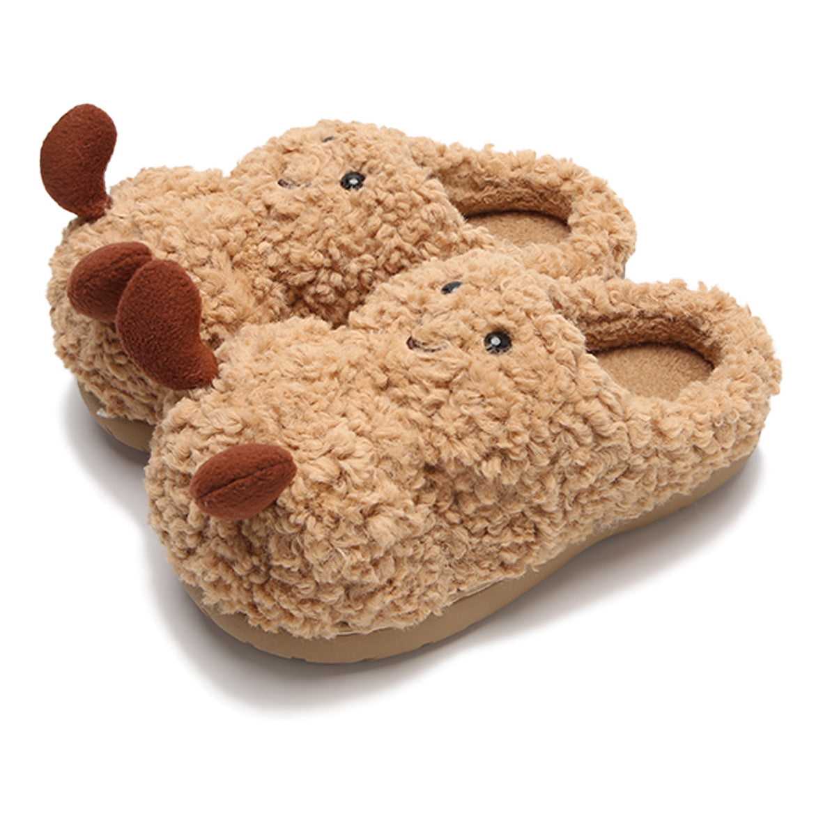 Fluffy camel-brown slip-on slippers shaped like reindeer with embroidered eyes, smiles, and brown plush antlers.