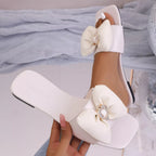 Open toe bow sandal by Trendsi, stylish women's shoe with a open toe design and decorative bow detail.