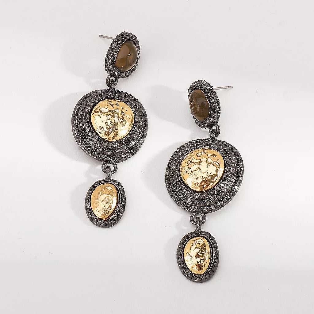 Vintage-inspired dangle earrings with gold accents, featuring intricate design and elegant craftsmanship.