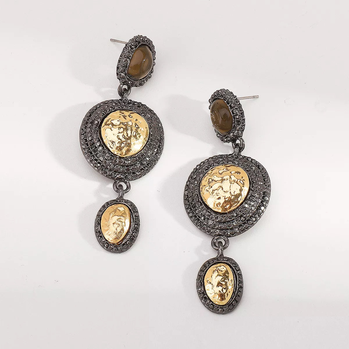 Vintage-inspired gold dangle earrings with intricate details, featuring elegant design and a polished finish.