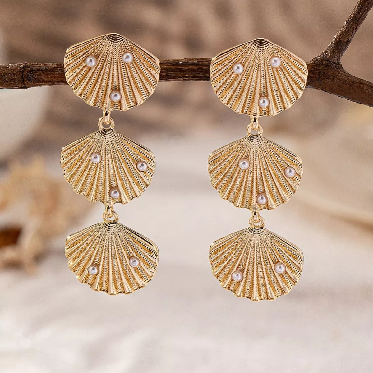 Seashell dangle earrings with pearl accents, featuring a delicate jewelry design from Plush Fashion Hub.