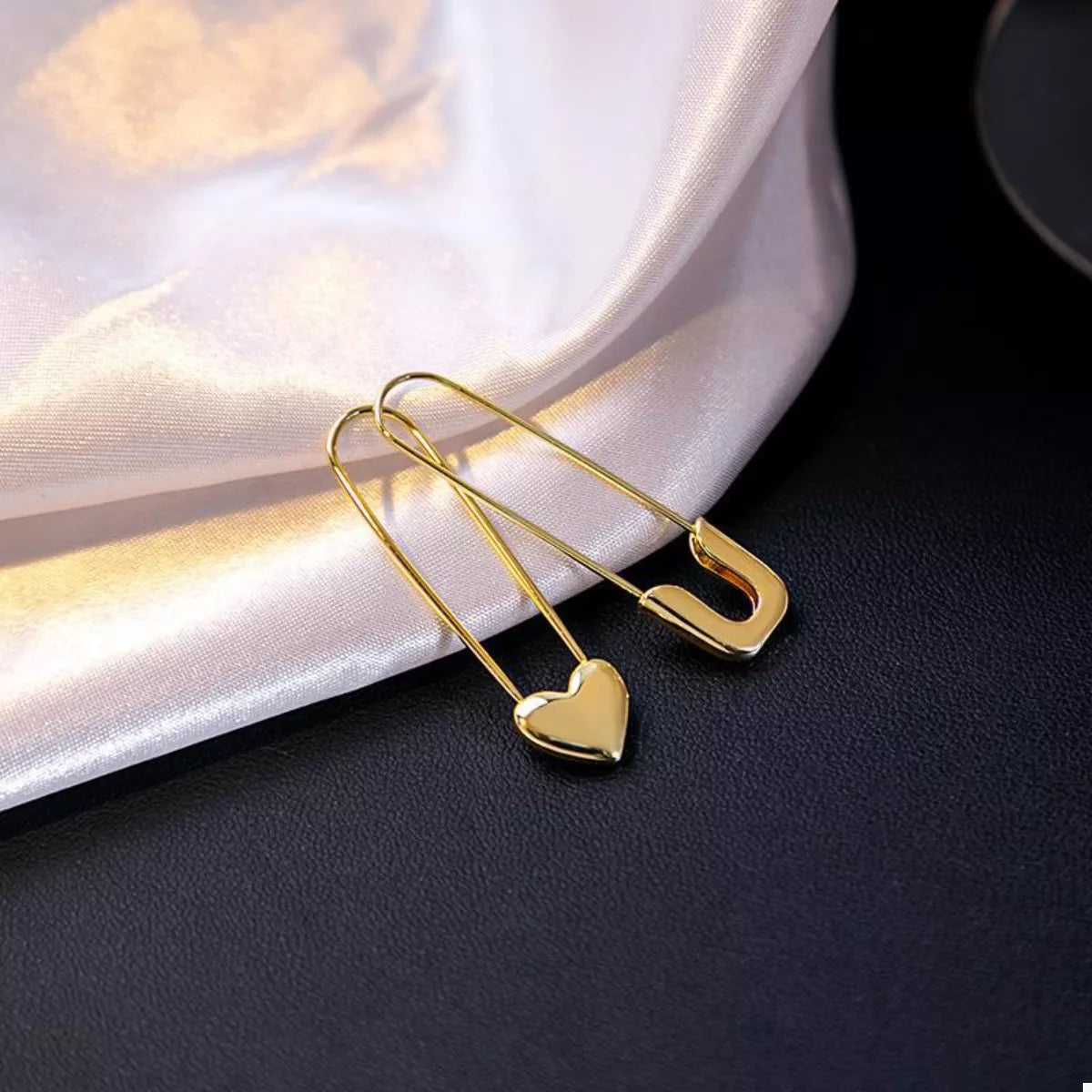 Gold-plated alloy heart safety pin drop earrings with a stylish design, perfect for fashionable accessories.