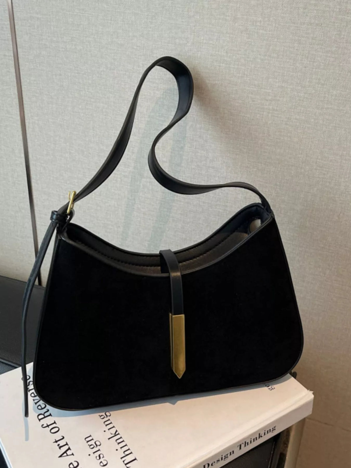 Adjustable strap shoulder bag from Plush Fashion Hub with a sleek design, featuring a spacious interior and stylish look.