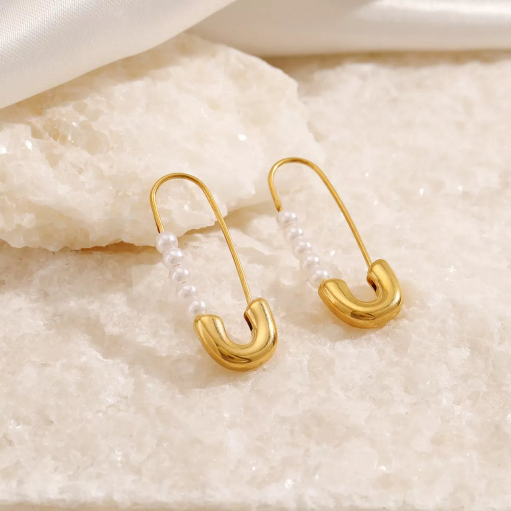 Safety pin pearl accent earrings by Shopimist featuring gold-tone safety pin design with elegant pearl embellishments.