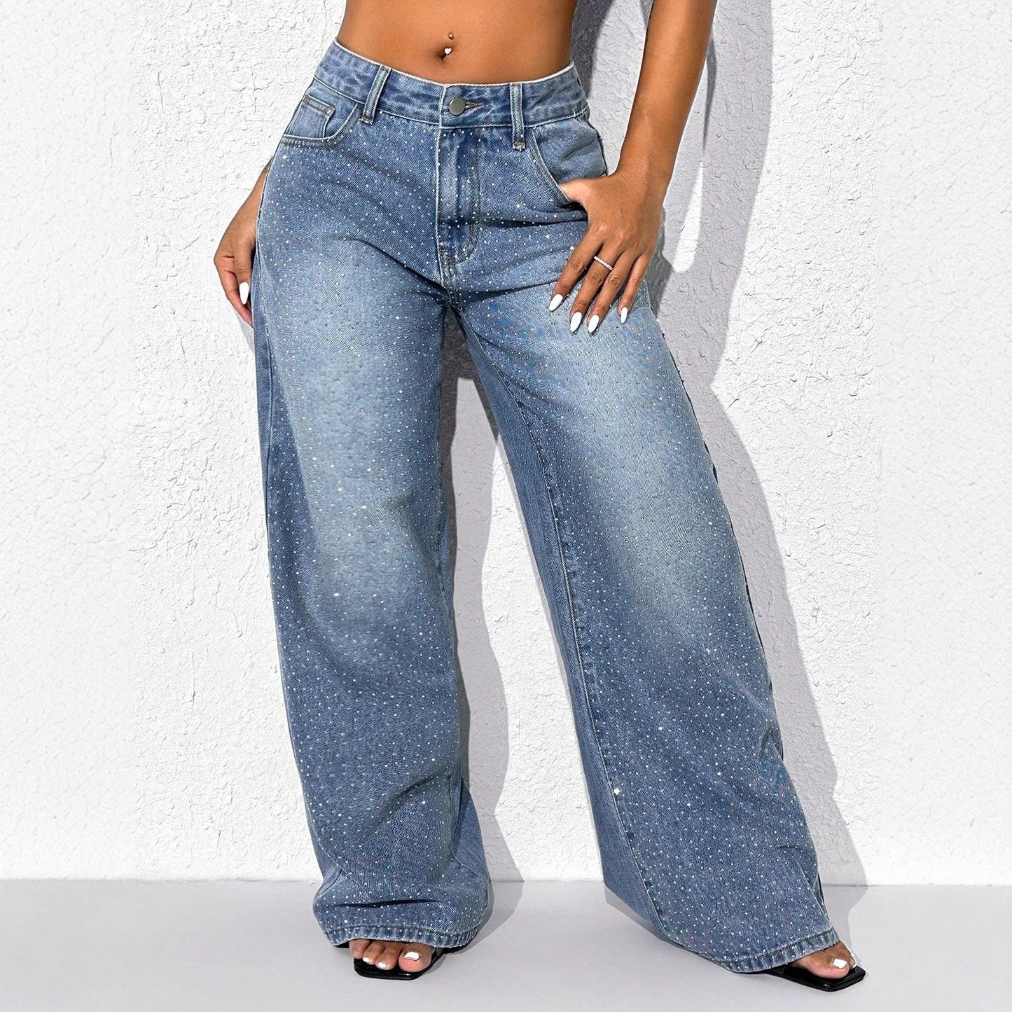 High-waisted embellished wide-leg denim jeans by Plush Fashion Hub, featuring decorative details and a relaxed fit.