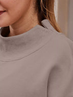 Women's oversized casual pullover sweatshirt with mock neck and dropped shoulders, Trendsi top in soft fabric, relaxed fit.