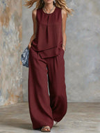 Women's sleeveless two-piece set with solid color wide-leg pants and matching top from Plush Fashion Hub.