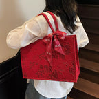 Floral embossed tote handbag with scarf accent from Shopimist, featuring textured floral design and stylish accessory details.