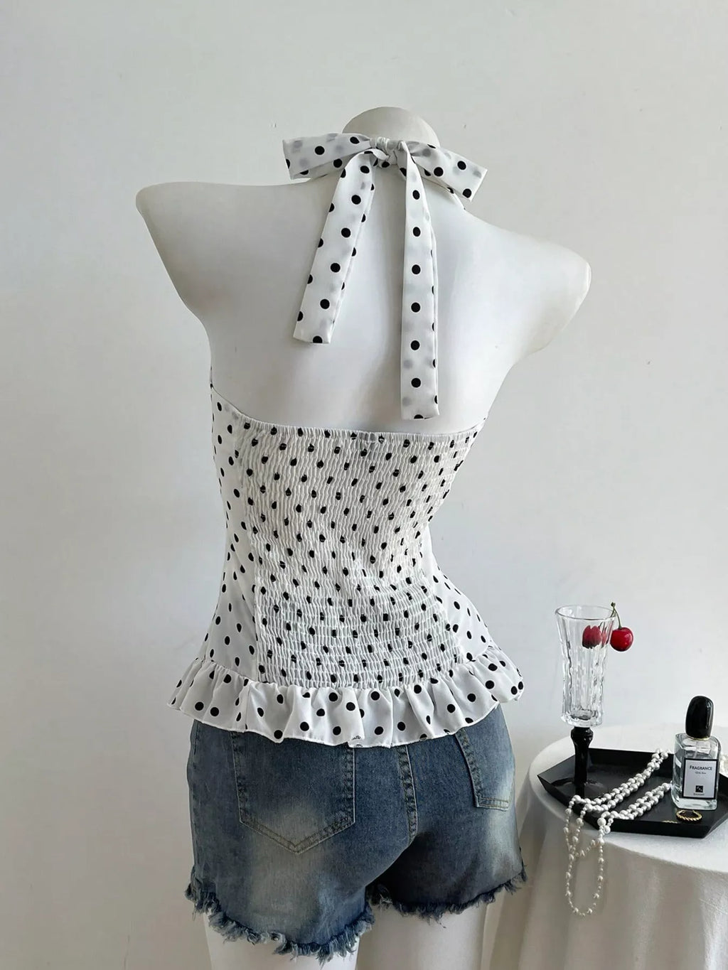 Polka dot halter neck cami top from Plush Fashion Hub, stylish shirts and tops with a playful polka dot pattern and halter design.