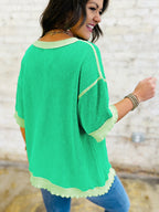 Women's ribbed twist hem short sleeve T-shirt with contrast stitching, showcasing the stylish design and textured fabric.