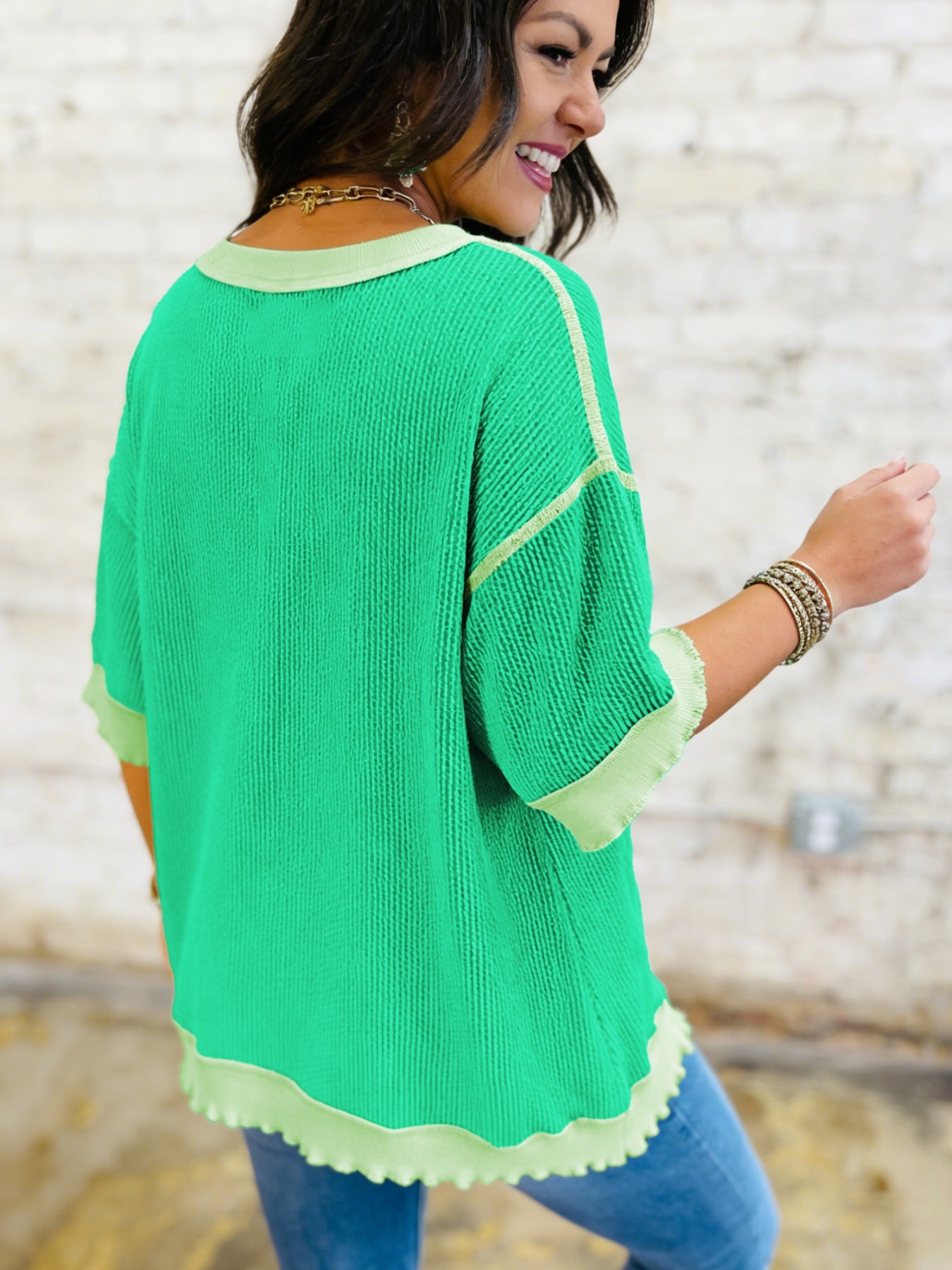 Women's ribbed twist hem short sleeve T-shirt with contrast stitching, showcasing the stylish design and textured fabric.