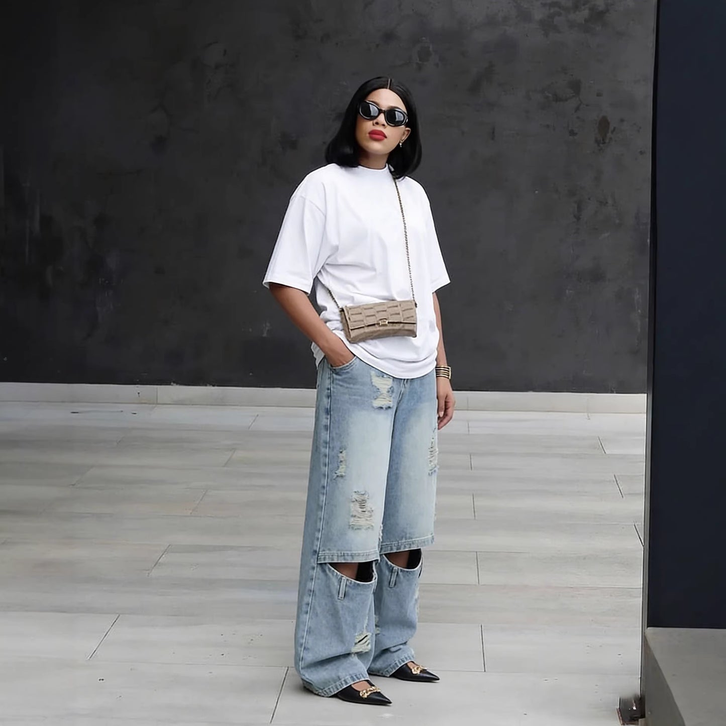 Light wash distressed ripped knee denim jeans by Plush Fashion Hub, showing the frayed knee design and casual fit.