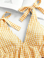 Gingham tie-shoulder mini dress by Plush Fashion Hub featuring a stylish skirt with a classic pattern and shoulder tie details.