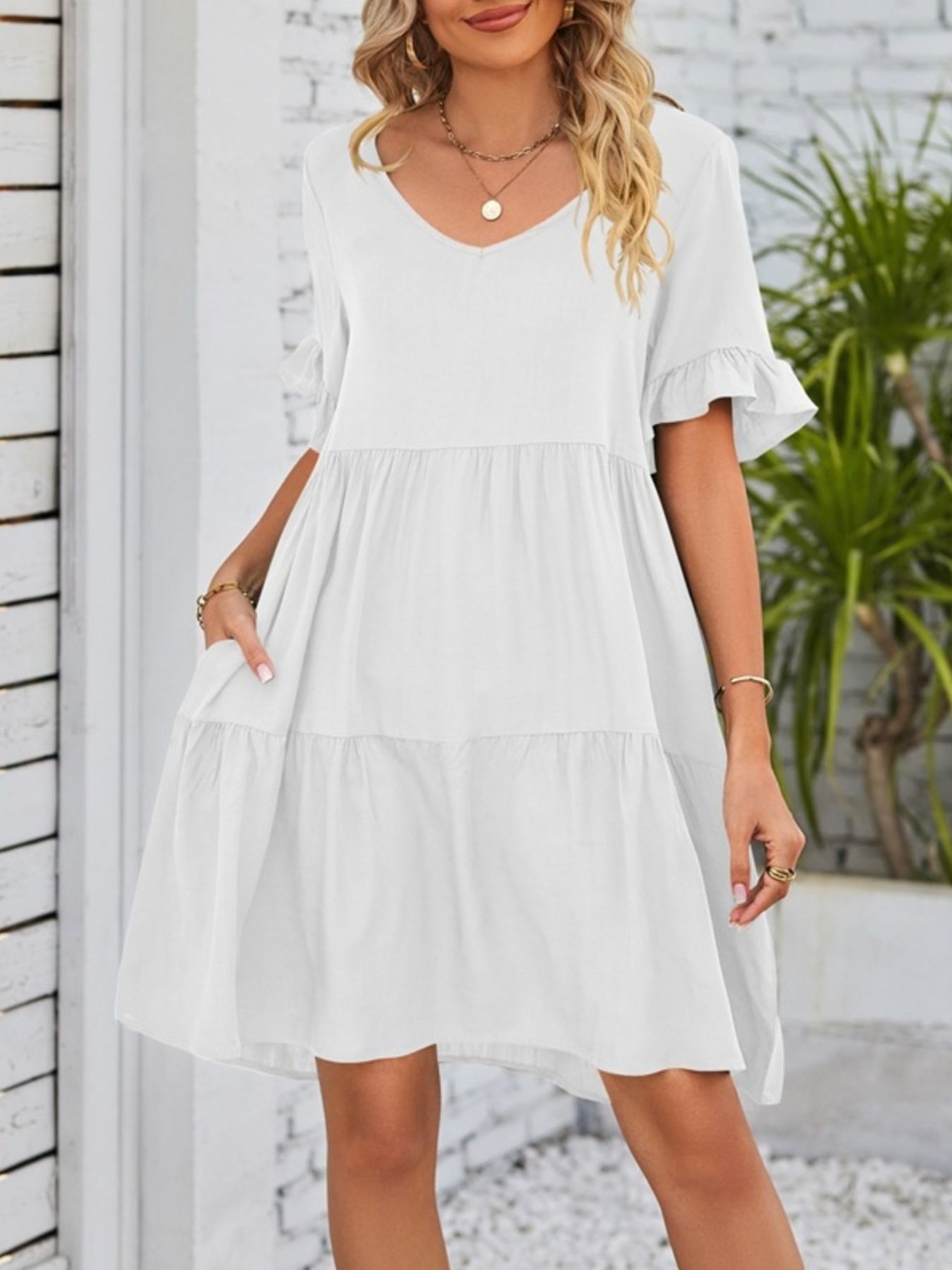 Lightweight rayon ruffled sleeve tiered mini dress with pockets, stylish and feminine, perfect for casual or summer wear.
